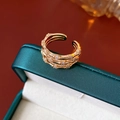 Detailed close-up of golden bamboo joint ring with sparkling zircons on a jewelry box - Ring - Gold