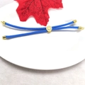 Macro detail of adjustable blue woven rope bracelet with 18k gold plated tree bead - Sky Blue