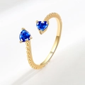 Adjustable gold plated ring featuring two sparkling blue heart-shaped cubic zirconia stones - September (Dark Blue)