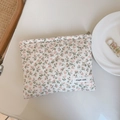Close-up of pink floral quilted cotton pouch with delicate embroidery and logo detail - Nude Pink Tiny Floral