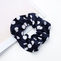 Elastic navy blue velvet scrunchie with white polka dots pattern on a desk - Style 7 Blue with White Dots