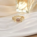 Detail of gold ring with pink round stone and hollow star patterns on a ceramic tray - Pink Round Gem Hollow Star Ring (JZ0144)