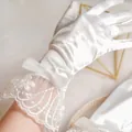 Elegant white satin bridal gloves with floral lace trim and delicate bow detail - Bow Lace Style