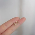 Minimalist 925 silver gold star and moon stud earrings shown on finger for scale - Star and Moon / Gold