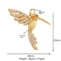 Golden hummingbird jewelry pendant with white crystals and red gemstone eye detail - Hummingbird-Gold
