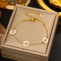 Detailed shot of golden stainless steel bracelet with white pearl flower charms and lobster clasp - Gold Pearl Flower Fine Chain (LM713)