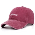 Close-up of COYENRAT embroidery on washed cotton burgundy baseball cap with retro texture - Burgundy