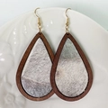 Detail view of teardrop leopard print wood earrings on a white ceramic plate - Wood/Silver Grey Hair