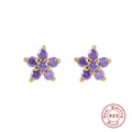 Macro detail of gold plated 925 silver star stud earrings with purple zircons - Gold-Purple Red