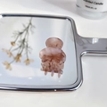 Mini acetate hair claw clip in pink marble finish placed on a vintage silver hand mirror - Jelly Purple
