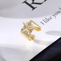 Macro shot of gold adjustable starfish ring with hammered texture and sparkling stones - Starfish Rhinestone