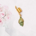 Close-up of golden dreadlock spring ring with a green striped shell charm accessory - Large Conch Style