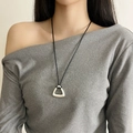 Minimalist silver flower pendant necklace with black cord cord on a model - Silver Triangle