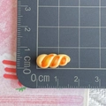Miniature pretzel resin charm for DIY crafts showing size measurement on ruler - Twisted