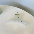 Detail of transparent hair claw clip with black polka dots and durable metal spring - White Hanger