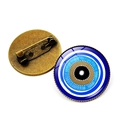 Detailed front and back view of a blue evil eye brooch with a bronze metal pin backing - Bronze-9
