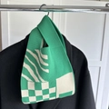 Green and white knitted wrist bag with checkerboard pattern and geometric stripes - Green Checkerboard Zebra