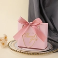Pink wedding favor box with a silk bow and golden Thank You text on a decorative tray - Pink Box + Leather Pink Ribbon