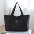 Black high-capacity canvas travel duffel bag shown on a silver suitcase for business trips - Large / Black