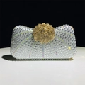 Detailed close-up of sparkling silver rhinestones and gold floral clasp on luxury evening clutch - Silver
