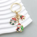 Christmas keychain with golden penguin, wreath and bell charms on artistic base - Penguin Wreath Bell Style (ER819)