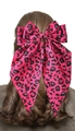 Pink leopard print ribbon bow hair clip on long brown wavy hair for a vintage style - Rose Pink Leopard Print