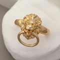 Hip hop style gold lion head ring with movable biting hoop on a stone base display - Lion Head with Ring / Gold