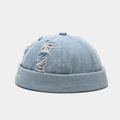 Detailed view of light blue distressed denim brimless cap with ripped street style textures - Adjustable / Distressed Light Blue Denim
