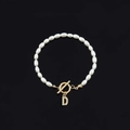 Elegant white oval pearl bracelet featuring a gold letter D charm and OT toggle clasp - Gold Letter D (SL2013)