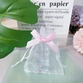 White organza gift bag with pink drawstring ribbon and translucent texture for favors - Pink