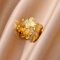 Hollow flower gold-plated titanium steel open ring resting on beige silk fabric - Adjustable Open / Flower Cluster (JZ5892G)