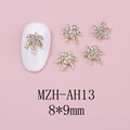 Detail of 8x9mm golden maple leaf nail art charms with white crystals on pink background - Gold Base White Rhinestone (AH13)