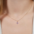 Elegante goldene Halskette mit lila ovalem Zirkonia-Anhänger an einem Modell - Wassertropfen Hellvioletter Zirkon + Perlenkette