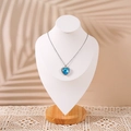 Blue heart pendant necklace with sparkling diamonds on a wooden portrait display - Large / White PU Leather