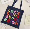 Detail of colorful chenille embroidery text on durable dark blue canvas tote bag - Navy Blue