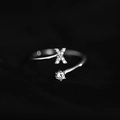 Adjustable silver ring featuring a micro-paved letter X and a sparkling round solitaire - Letter X