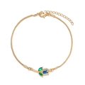Detail of gold snake chain bracelet with blue tulip pendant and green crystal leaves - Bracelet-Blue