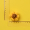 Handmade crochet sunflower keychain accessory in yellow wool yarn shown with ruler scale - Yellow Sunflower Doll