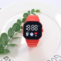 Detalle de reloj digital LED rojo con iconos de astronauta y correa de silicona en plato - Rojo