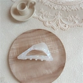 Close-up of holographic triangular hair claw clip on wooden tray with lace decoration - Large Triangle / AB White