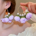 Detail of purple fabric flower earrings with white pearls and gold metal hoops on model - 55# Silver Earring Post - Purple