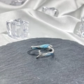 Detailed view of silver snake-shaped ring with blue gemstone on black stone background - Style 10 Adjustable Ring