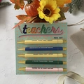 Five-piece teacher gift pen set with humorous quotes and gold accents on card backing - Teachers Theme