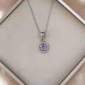Detailed close-up of a silver necklace featuring a sparkling purple zircon round pendant - Silver Purple Zirconia