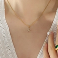 Gold plated Y-letter necklace with sparkling zircon pendant on female model - Letter Y / Gold