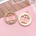 Gemini zodiac pendant in golden alloy with rhinestones, showing front and back textures - Gemini