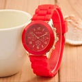 Geneva silicone watch in red and gold finish on a rustic wooden table background - Red