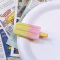 Close-up of a pink and yellow gradient popsicle hair clip on a white ceramic plate - Pink-Light Yellow Gradient Popsicle Hair Clip