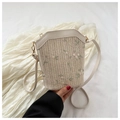 Detail of straw bucket bag featuring green leaf and pink floral embroidery accents - Off White