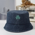 Navy blue washed denim bucket hat featuring green shamrock embroidery and metal eyelets - Navy Blue
